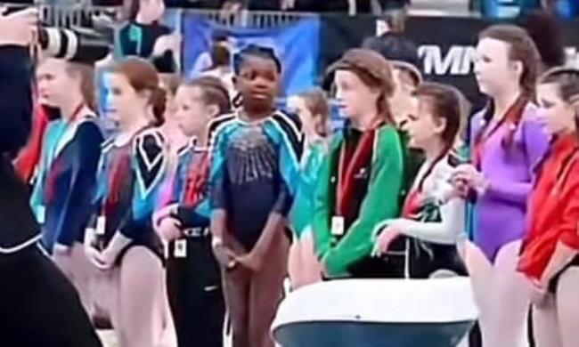 A line of young girls at a medal ceremony